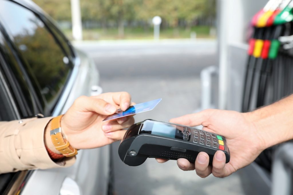 Handing over card for gas payment